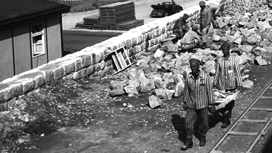 Prisioneros de Mauthausen transportan piedras para la construcción del campo