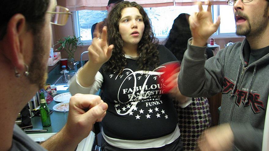 Adultos comunicándose en lengua de signos (Foto: daveynin | Flickr)
