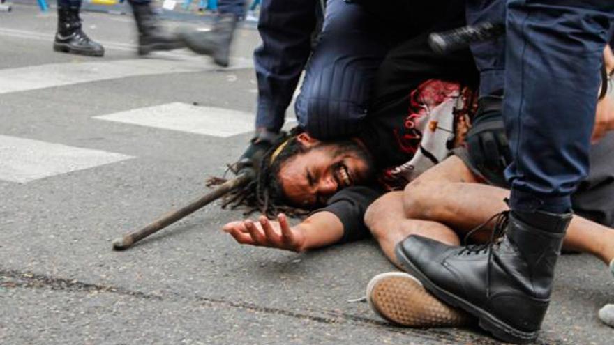 Policías antidisturbios aplastan a un manifestante el 25S. Foto: Fotogracción